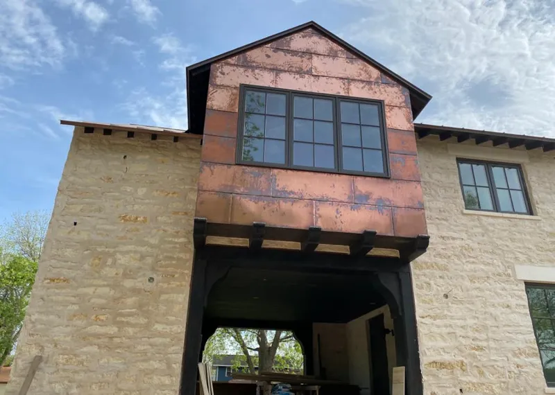 Copper metal panel facade on a stone building for Skylight Installation in Mount Carmel